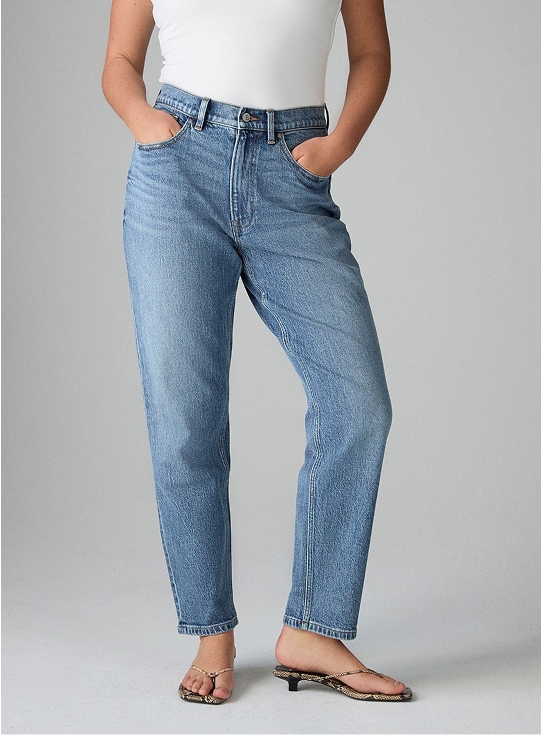 Model wearing mid-wash comfort stretch jeans