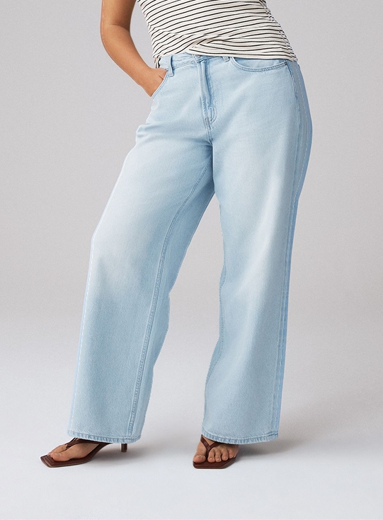 Model wearing light-wash rigid wide-leg jeans